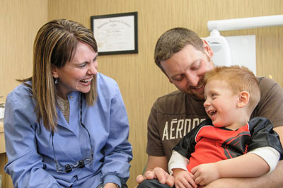 Dr. Docia Hogan with son and father at dh Dental Care